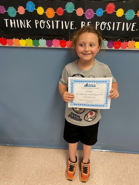 Jax Pfadt, Lincoln's Stairclimber for October, poses with his award plaque.